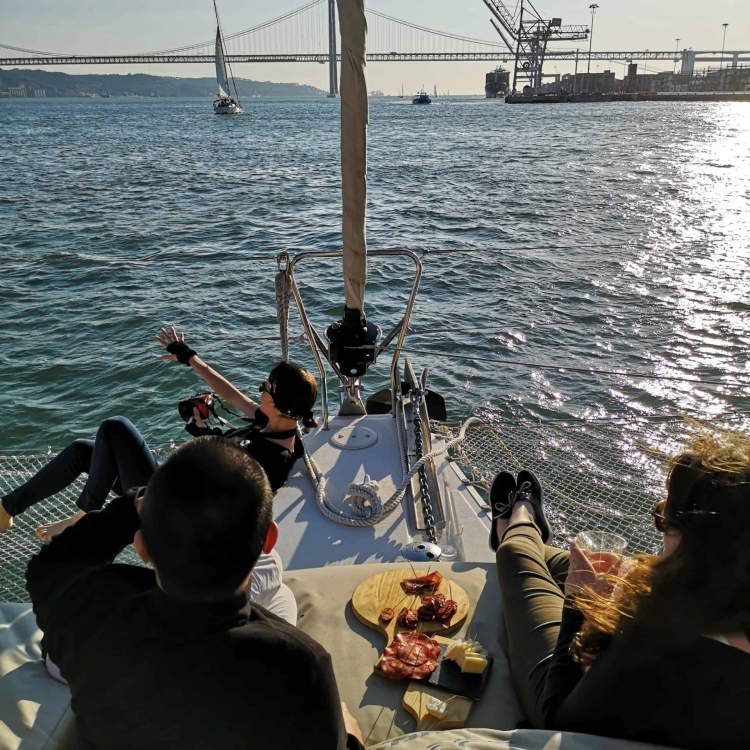 Early evening aperitif on the Tagus: cheese and charcuterie tapas on a catamaran in Lisbon during sunset
