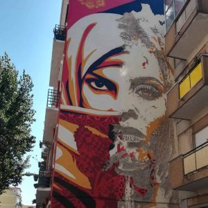 Street art by Vhils in collaboration with Shepard Fairey OBEY in the popular district of Graça