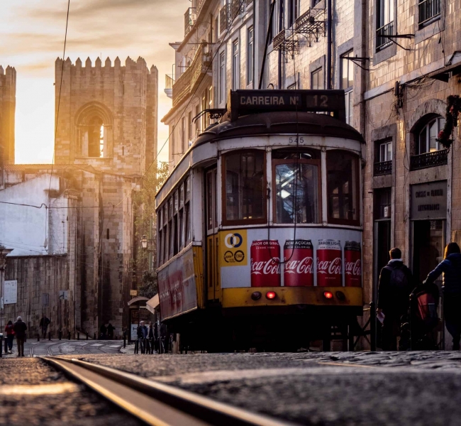 Lisbon travel guide, tram 28 in the Alfama district with Sé Cathedral in the background